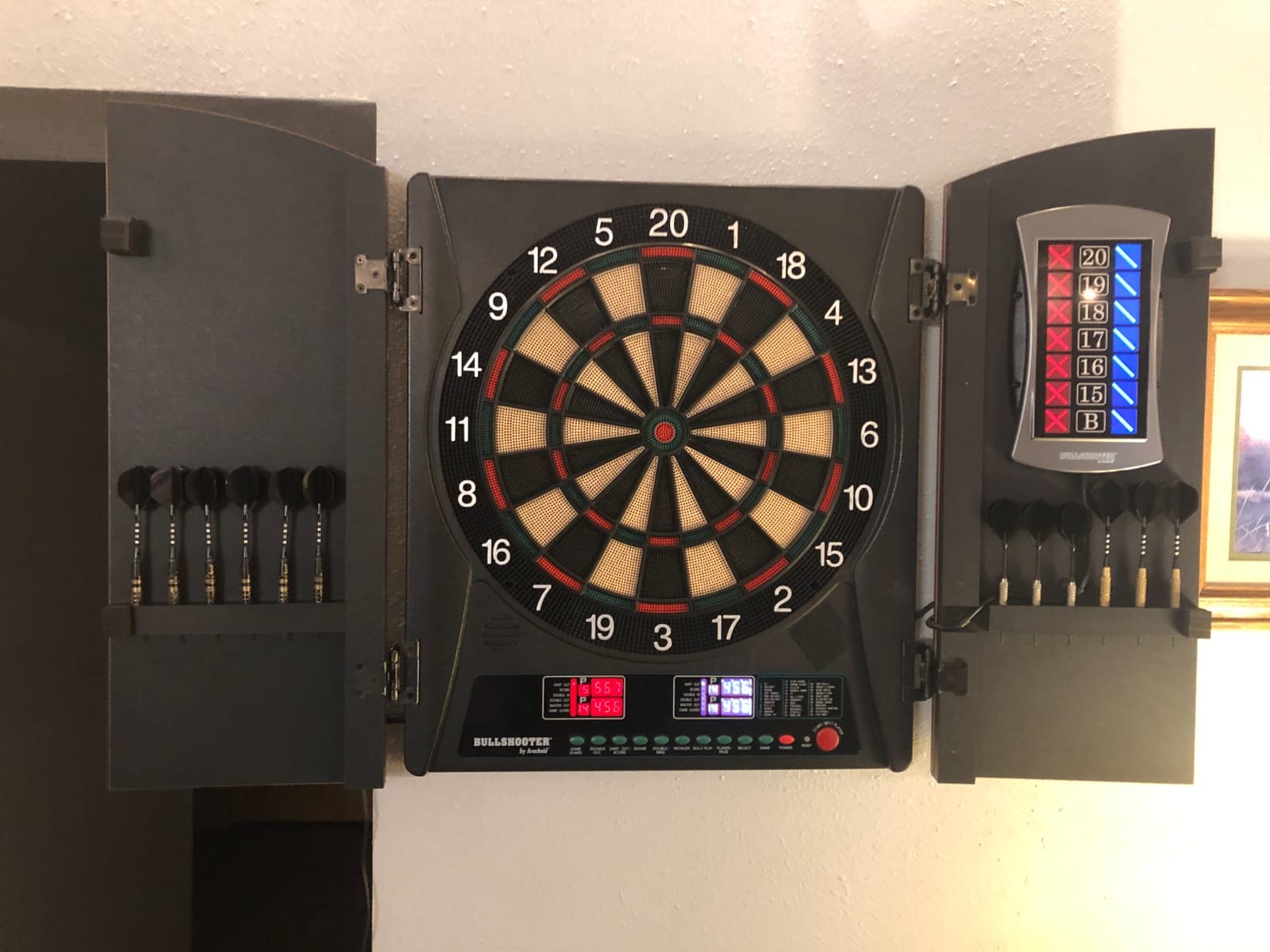 Arachnid CricketMaxx 1.0: 13.5” recreation size with wood cabinet. Features 34 games, 183 variations, 8-player LED X/O scoring, and Heckler mode. Integrated storage for darts and accessories customer photo 2